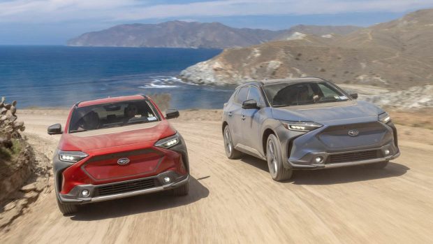 2023 Subaru Solterra twins front angle driving shot with ocean in background