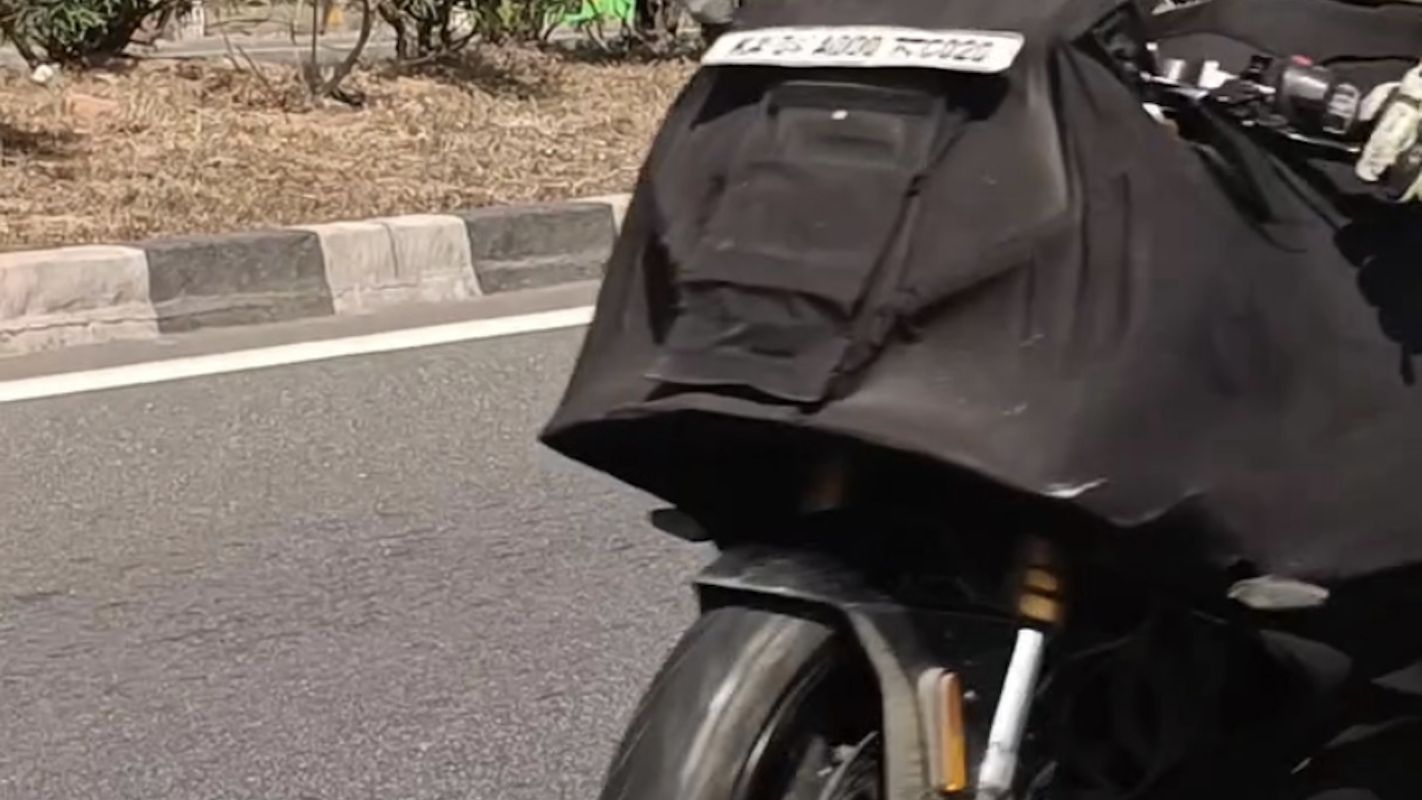 TVS Apache RR 450 under black cover. Credit: Facebook/Bikewale.