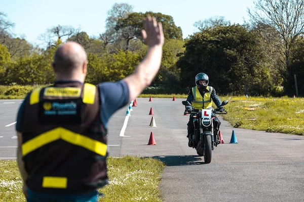 Motorradschüler und -lehrer führen eine Übung durch
