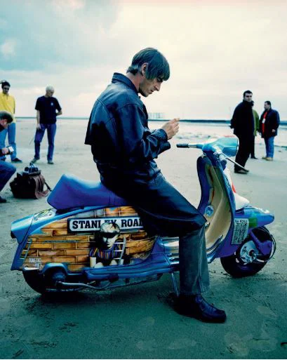 Paul Weller sitzt auf einem Roller